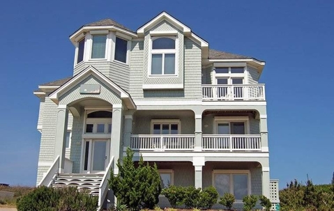 The facade of a 3-story white house